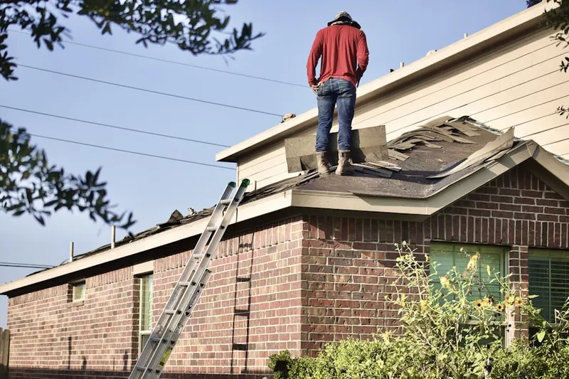 Professional roofer working on a residential roof in Burns Crossroads
